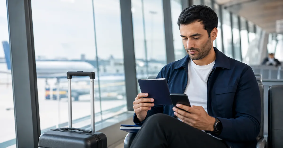 Traveller checking trip documents before boarding at an airport gate